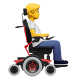 मोटर व्हीलचेयर पर बैठा व्यक्ति: दाईं ओर चेहरा घुमाए